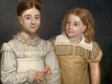 portrait of two young girls, one in a yellow dress and the other in a white dress