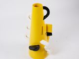 a close up of a yellow cone shaped object with a black handle