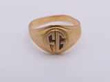 a gold signet ring with a cross in the middle