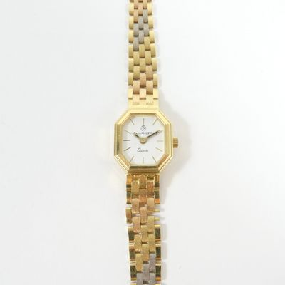 a gold and silver watch with a white face