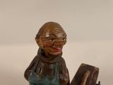 a statue of a man with a suitcase on a table