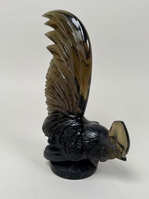 a black and brown bird figurine sitting on a white surface