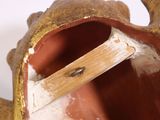 a close up of a vase with a toothbrush sticking out of it