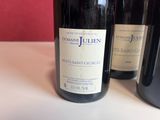 three bottles of wine sitting on a table next to each other