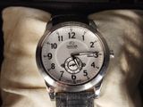 a watch that is sitting on a pillow in a box