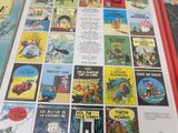 many children ' s books on a table with a teddy bear