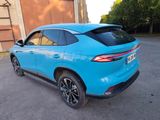 the rear end of a blue suv parked in a parking lot