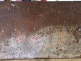 a rusted metal box sitting on a table in a room