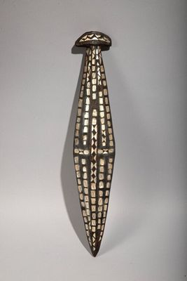 sculpture of a corn on a white background with a shadow on the wall