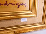 une image représentant un tableau dans un cadre doré, sur lequel figure une inscription en violet