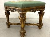 an image of a gold bench with a green cushion on it