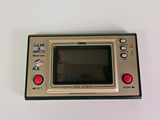 an old game console sitting on top of a white table