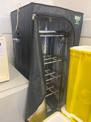an image of a kitchen with a yellow trash can and a black bag