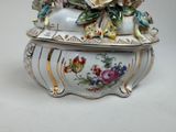 a white box with flowers on it on a table