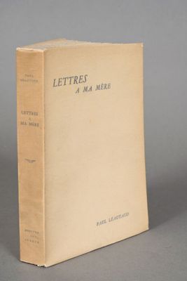 an old book sitting on top of a table on a gray surface