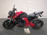 a picture of a red motorcycle parked on a checkered floor