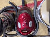 a picture of a red vacuum cleaner and other cleaning equipment