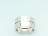a silver ring with a cross on it on a blue surface