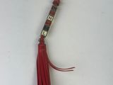 a keychain with a red tassel hanging from it