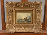 painting of a boat in a body of water on a wooden chair