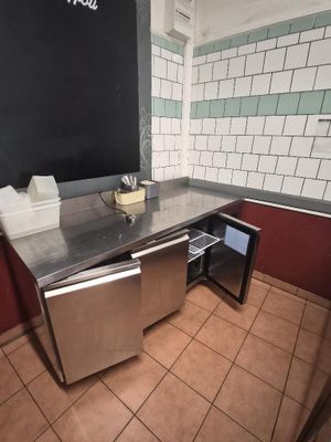 a blackboard on the wall of a public restroom