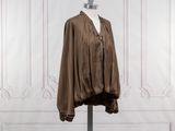 an image of a brown jacket on a mannequin stand