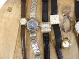 many different types of watches on a wooden board