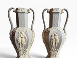 two white vases sitting side by side on a white surface