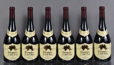six bottles of wine are lined up on a table