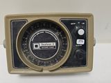 an old fashioned radio sitting on a white table