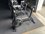 two stationary exercise bikes parked in a garage