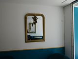 two chairs in a room with a mirror on the wall