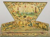 a small box with a painting on it on a table