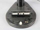 a black and white photo of a pen on top of a stand
