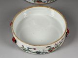 a white bowl sitting on a table next to another bowl