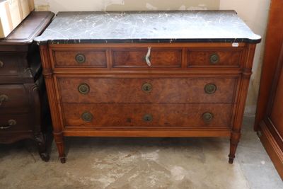 a marble top dresser in a corner of a room