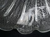 a close up of a glass vase on a black surface