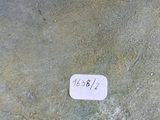 a white sticker that is on a stone wall
