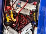 a blue trash can filled with assorted items