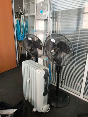 two fans that are sitting next to a radiator