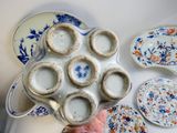 a person holding a platter of plates and bowls
