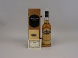 a bottle of whisky next to a cardboard box