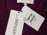 purple sweater with a tag on it and a name tag on it