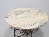 an image of a marble table with iron legs and a marble top