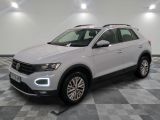 a white volkswagen suv is parked in a room with a checkered floor