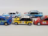 several toy cars are lined up in a row on a white surface