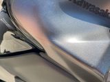 a close up of a motorcycle with a shiny cover on it ' s seat