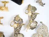 many different types of jewelry on a white surface