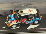 a miniature car in a clear display case on a table