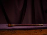 a wooden bat sitting on top of a purple cloth